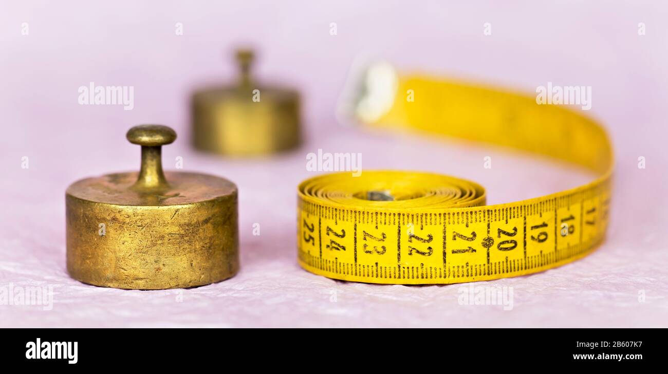 Weight loss, diet concept, copper weights and tape measure, web banner Stock Photo