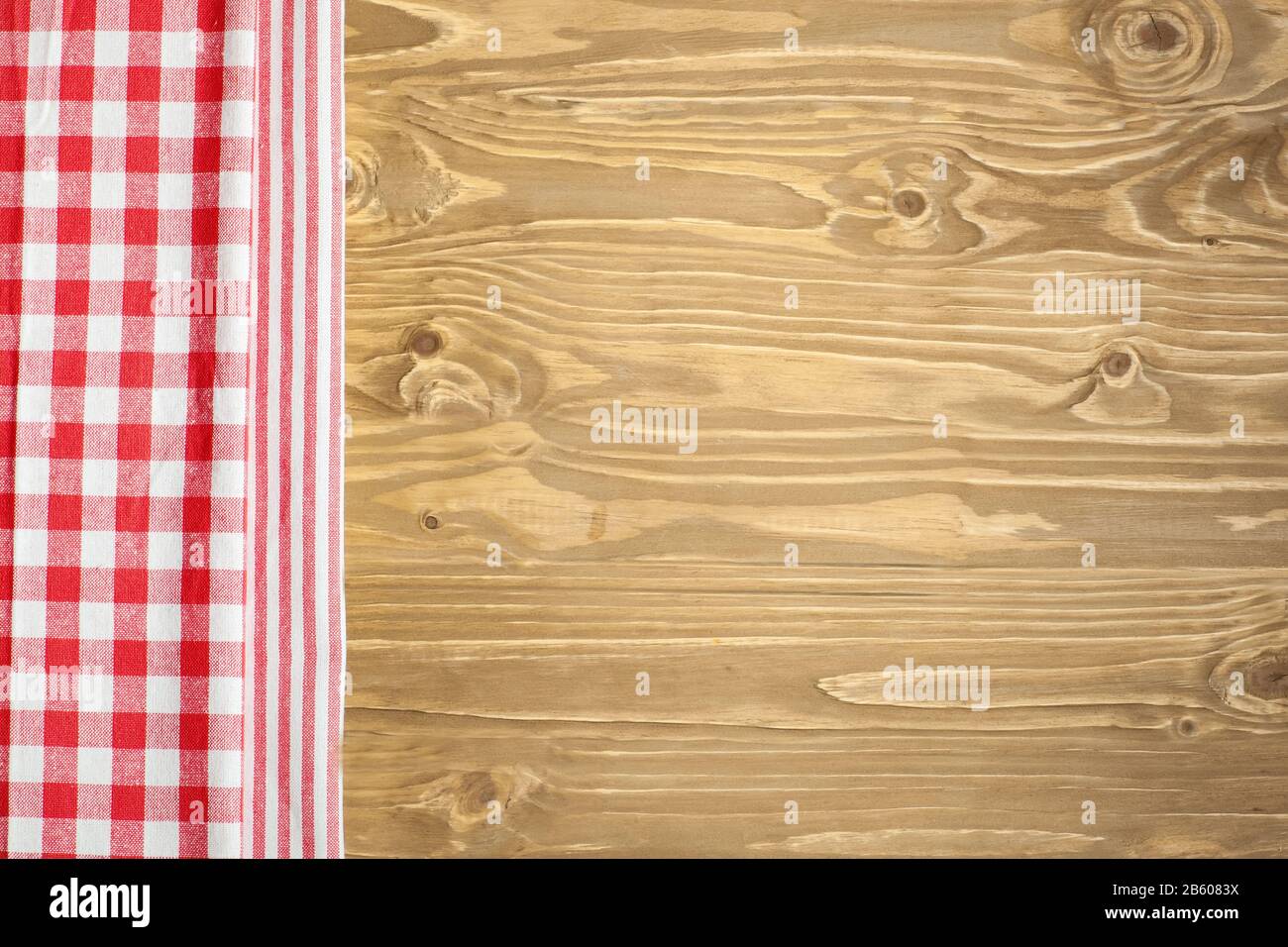 Checkered tablecloth on wooden table. Background with copy space