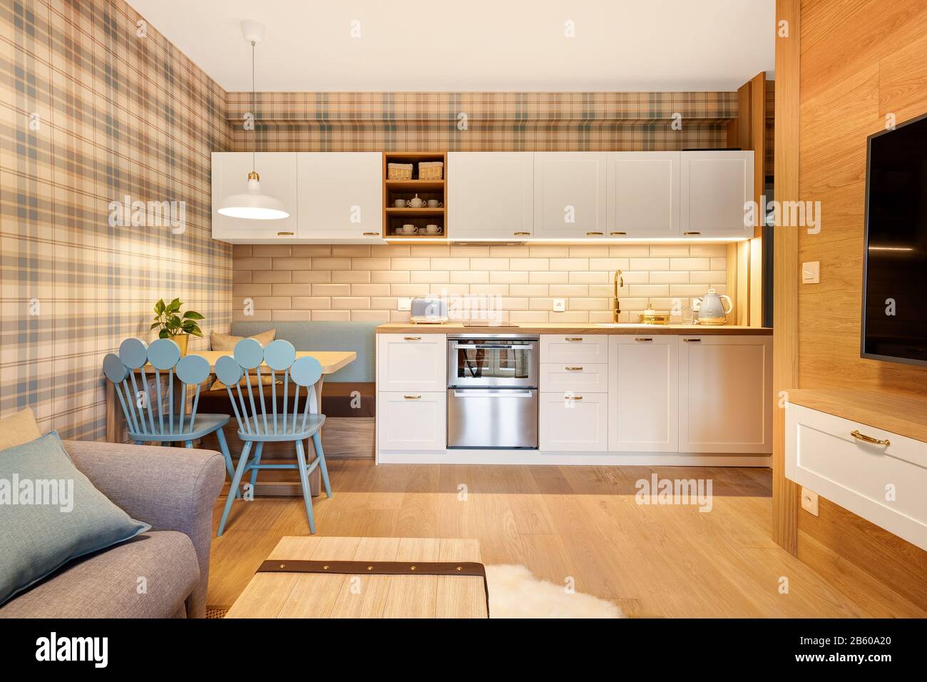 kitchen in wooden paneled apartment with blue accessories Stock Photo