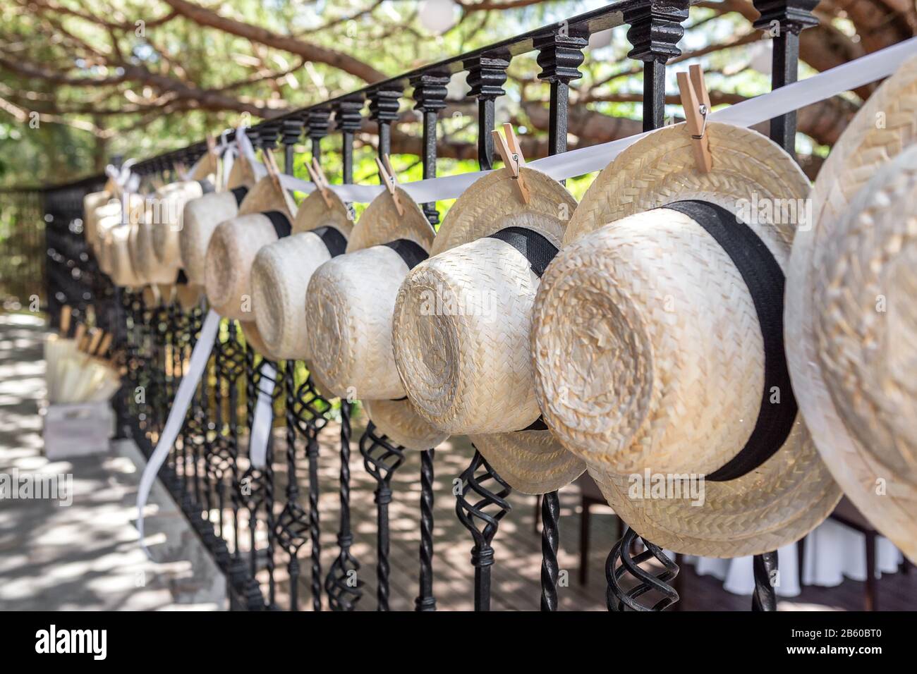 Straw hats for wedding decoration. Fense .Close-up Stock Photo - Alamy