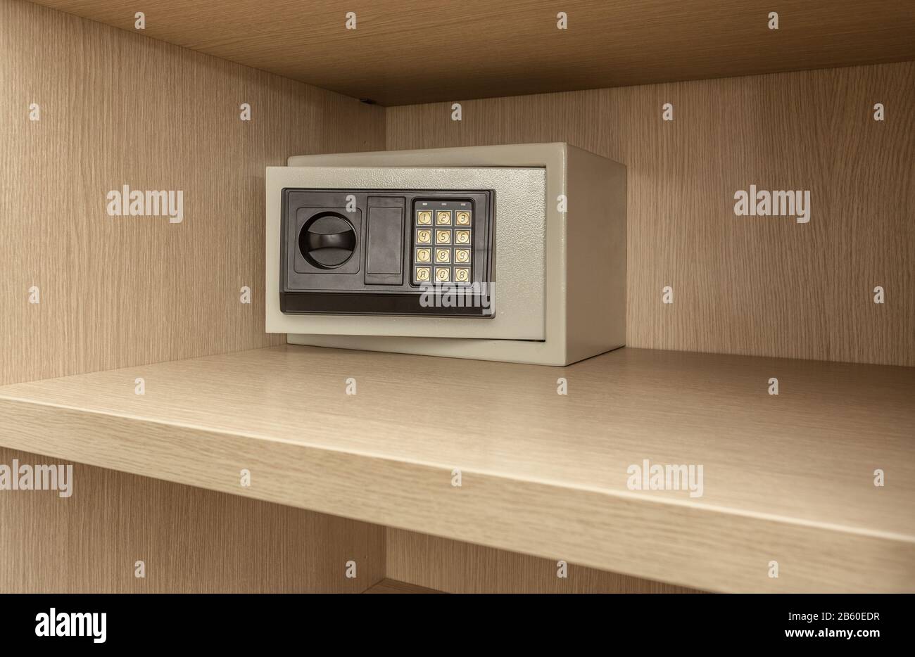 Safe box for storing valuables in a wooden cupboard. Inside Stock Photo