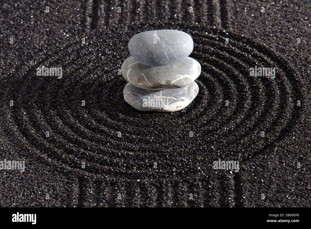 Japanese zen garden with stone in textured sand Stock Photo
