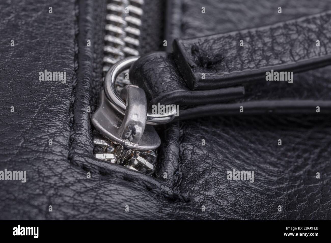 Lock the zipper from the leather bag. Close up Stock Photo