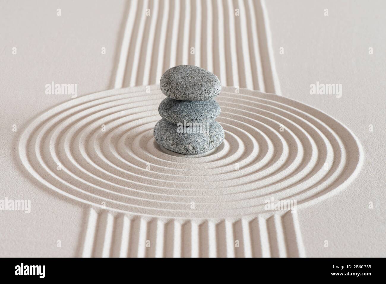 Japanese zen garden with stone in textured white sand Stock Photo