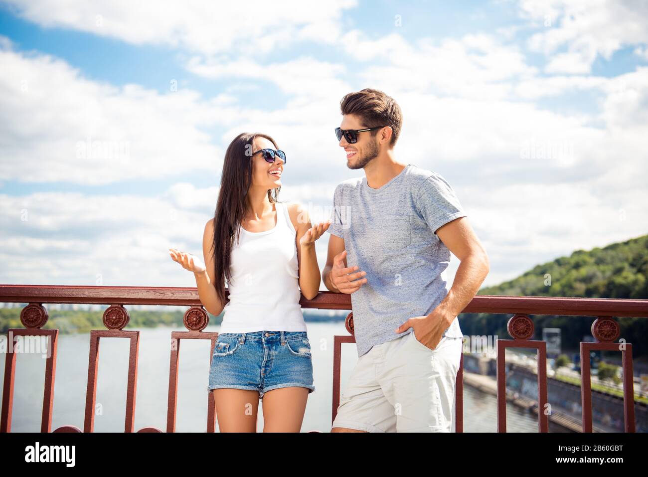 Young couple on the bridge having fun and smiling on weekend Stock Photo