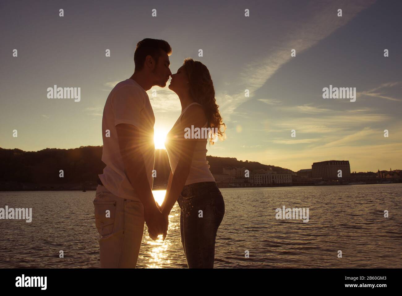 Silhouette of couple in love kissing and watching on the sunset Stock ...