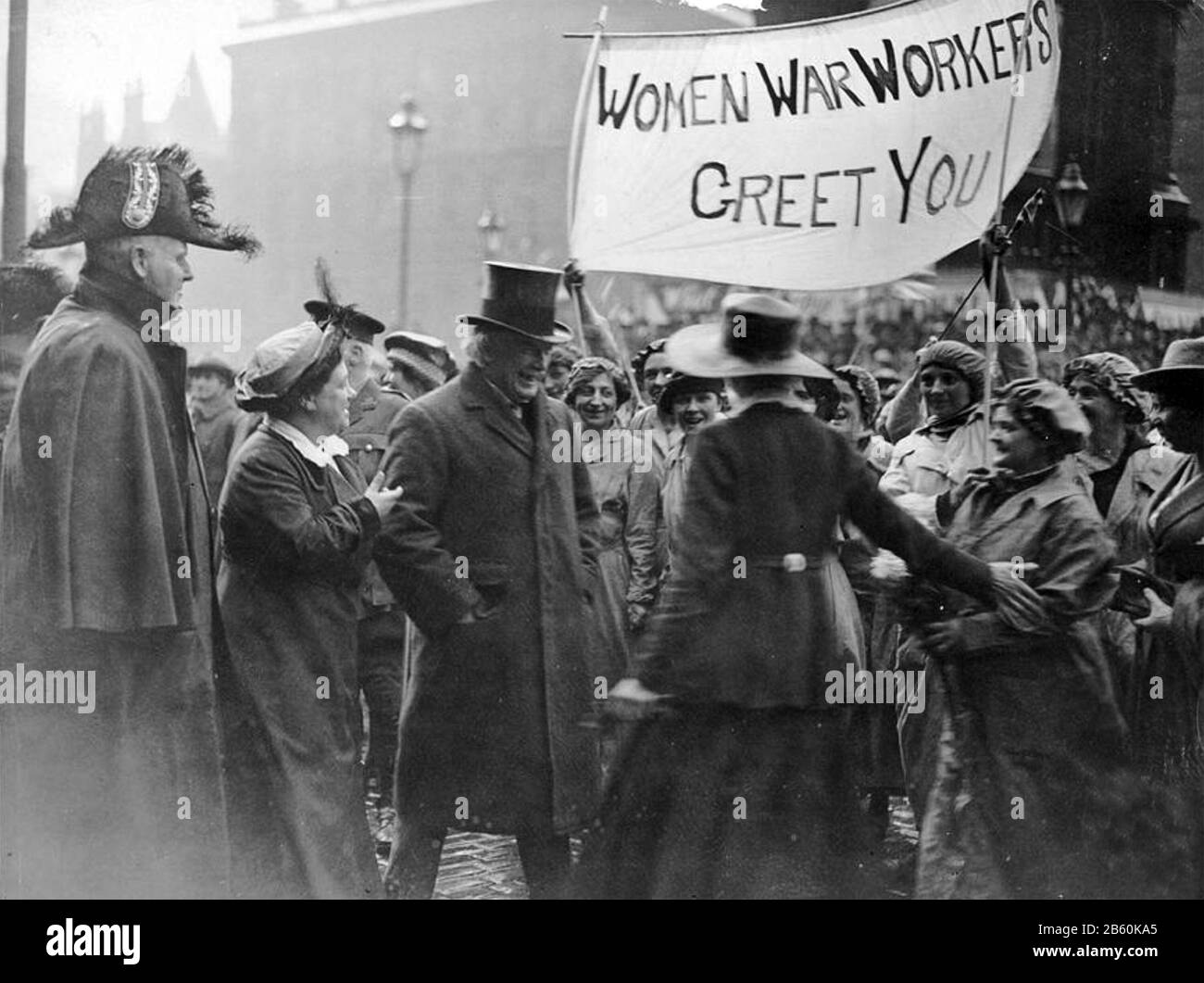 DAVID LLOYD GEORGE (1863-1945) as PM meeting women munitions workers in Manchester in September 1918. Leading suffragettes Flora Drummond at left and Phyllis Ayrton in wide brimmed hat make their case to the PM. Stock Photo