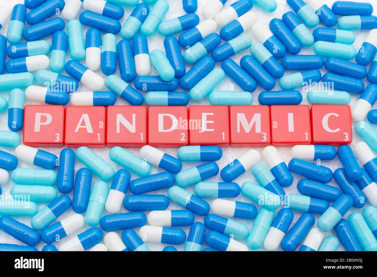 Drug capsules / pills & Letter tiles with word PANDEMIC. For 2020 Coronavirus pandemic, COVID-19, CV19, Wuhan virus, medication, SARS, MERS, new virus Stock Photo