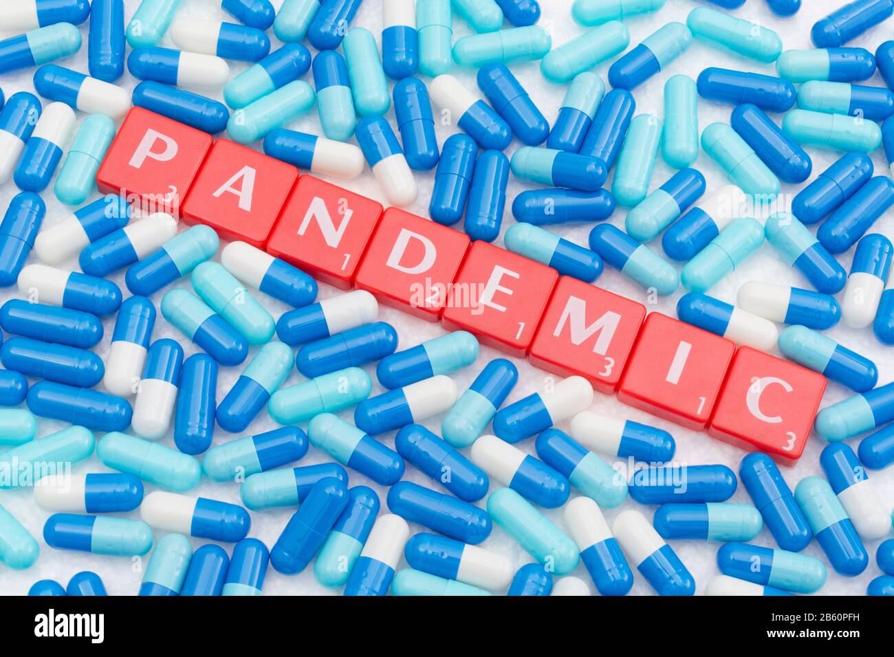 Drug capsules / pills & Letter tiles with word PANDEMIC. For 2020 Coronavirus pandemic, COVID-19, CV19, Wuhan virus, medication, SARS, MERS, new virus Stock Photo