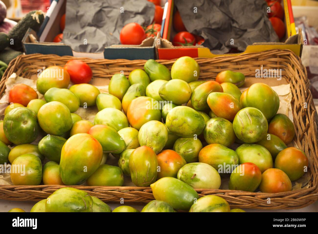 close-up pile of tomatoes in a wicker basket at the market Stock Photo