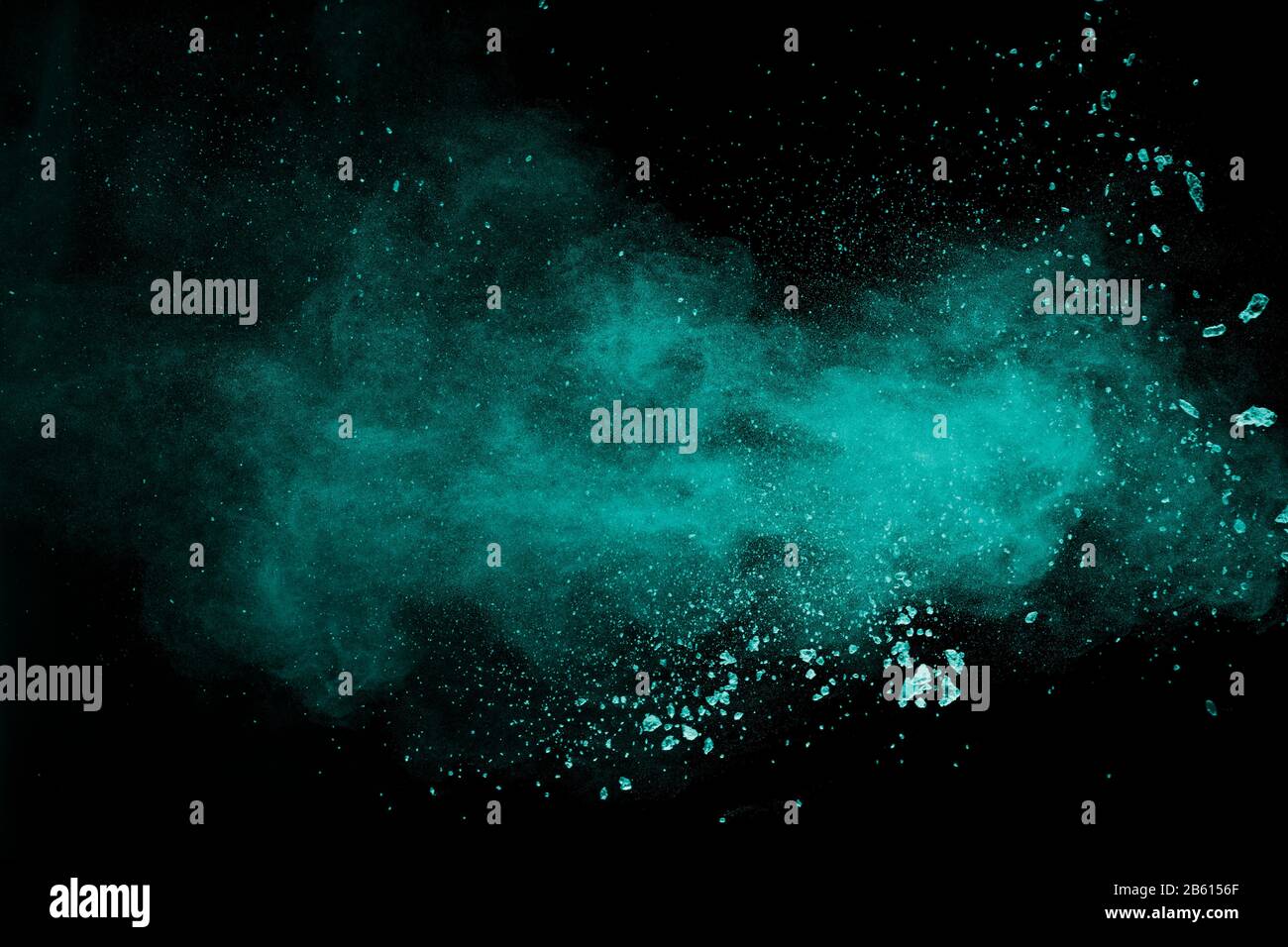 Abstract splash of green colored powder on black background.Green powder explosion. Stock Photo