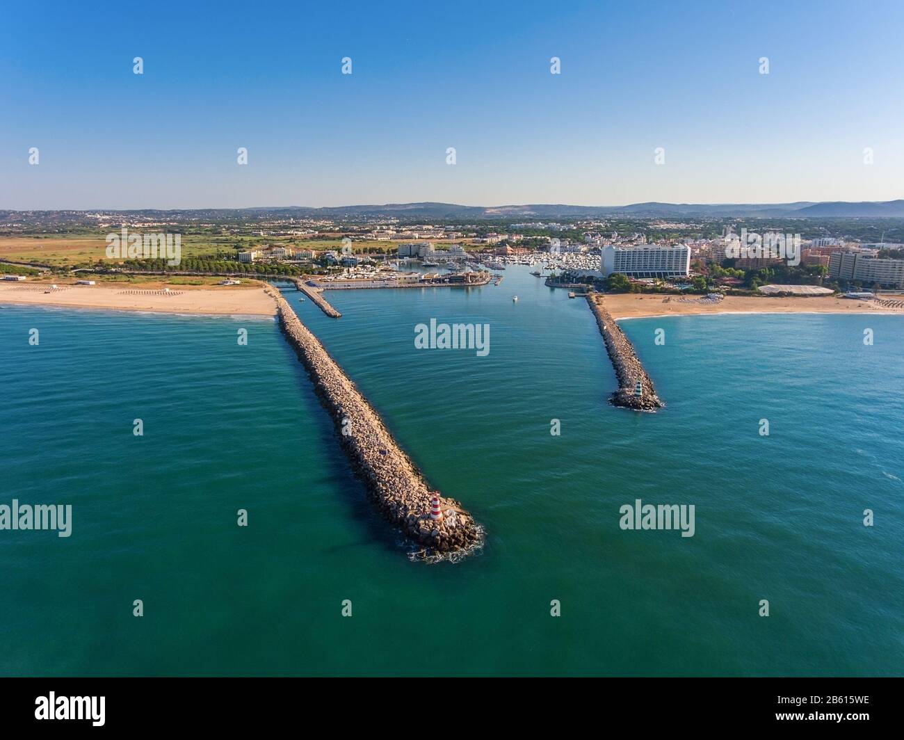 Entrance to the sea port for yachts. Breakwaters in the foreground. Stock Photo