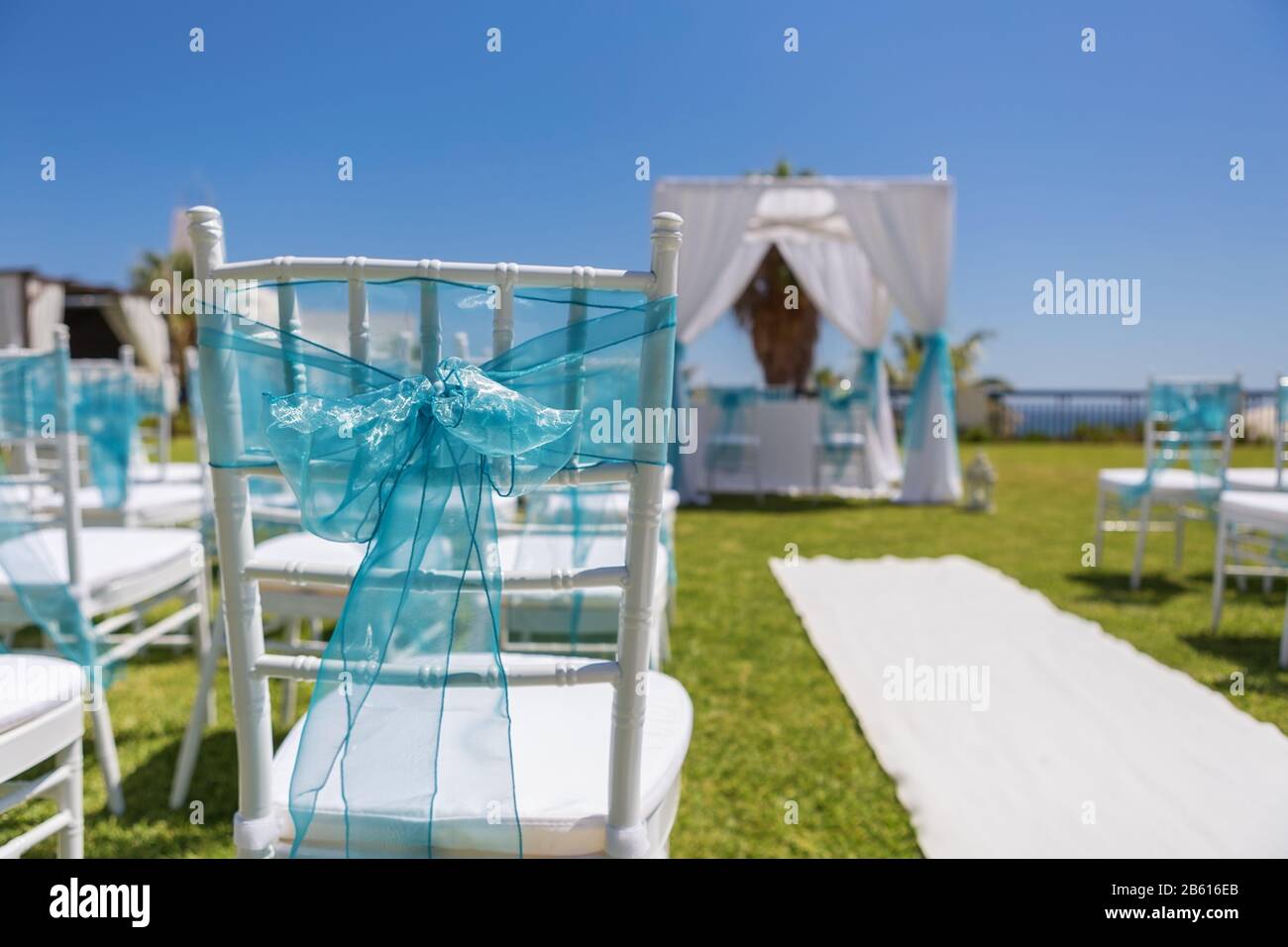 Decoration bow ribbon for a wedding ceremony. Chairs for guests Stock