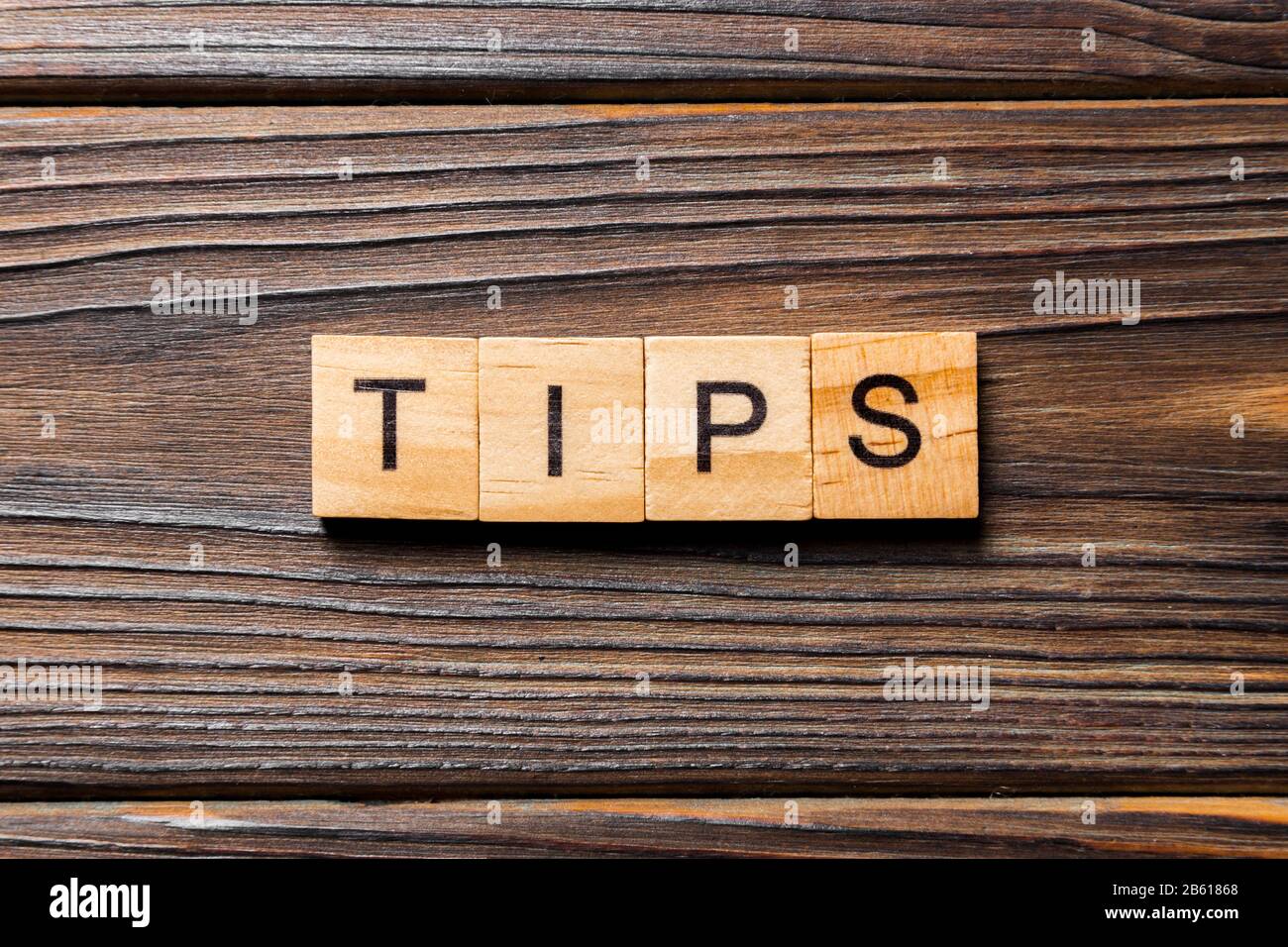 tips word written on wood block. tips text on table, concept Stock ...