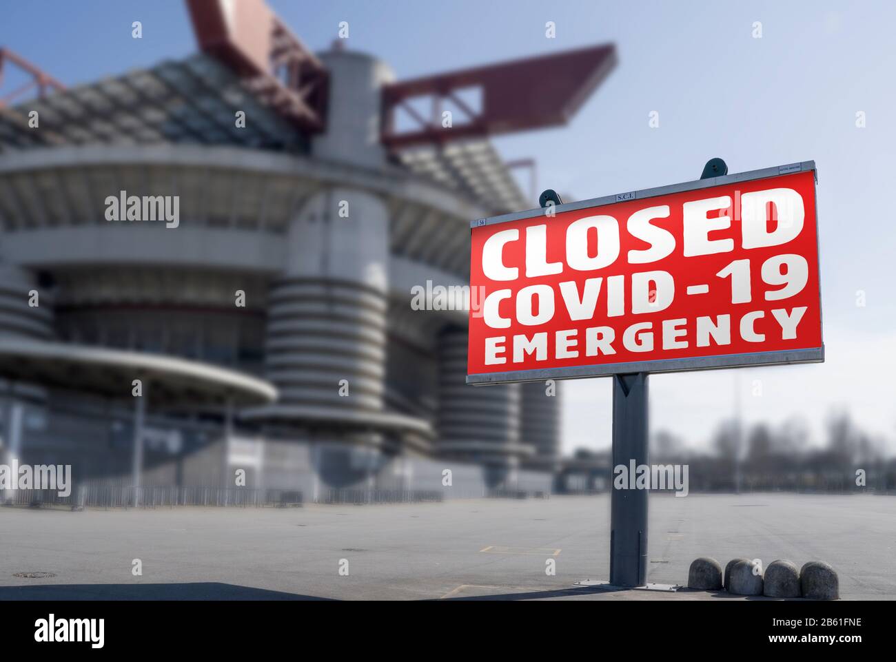 Red warning sign for Covid-19 in front of closed stadium. Concept of cancellation of sporting events due to corona virus medical emergency. Stock Photo