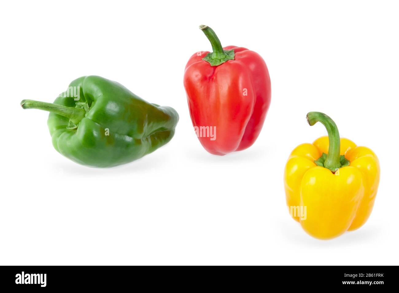 yellow, green and red peppers on a white background Stock Photo - Alamy