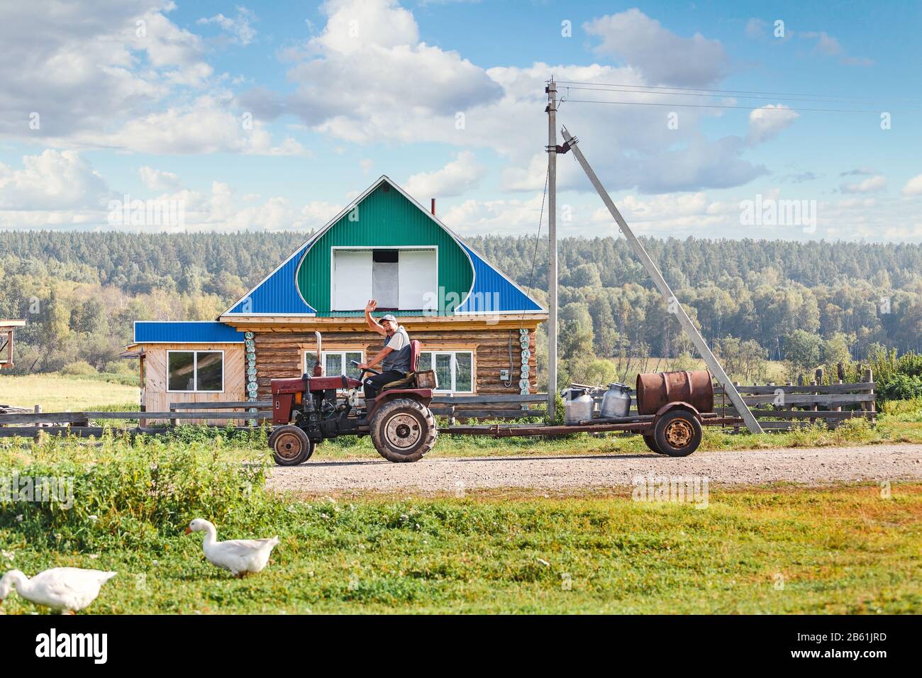 01 SEPTEMBER 2017, NIKOLAEVKA VILLAGE, BASHKORTOSTAN, RUSSIA: Man farmer rides on an old tractor in the village Stock Photo