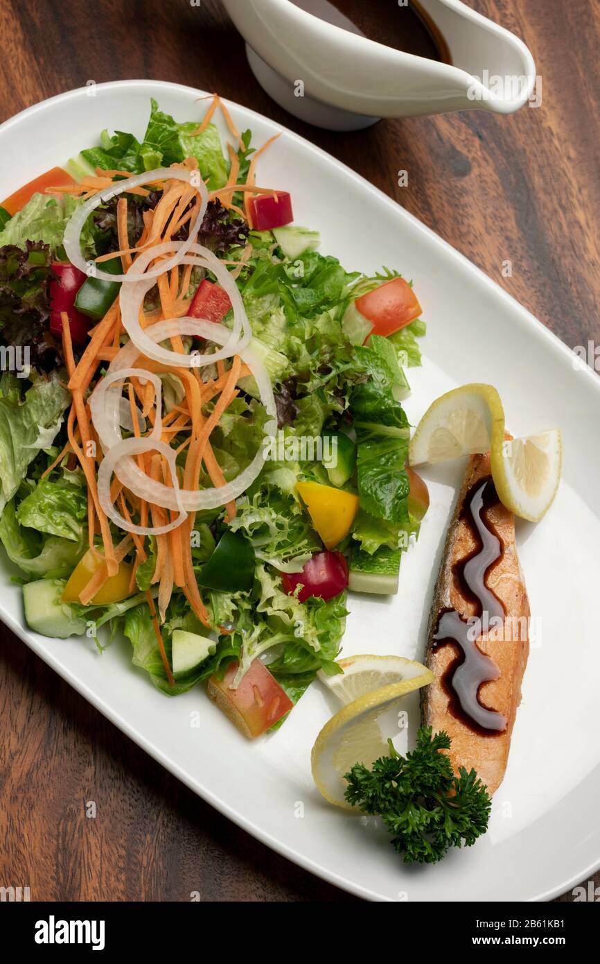 organic mixed vegetable salad with salmon fillet and balsamic