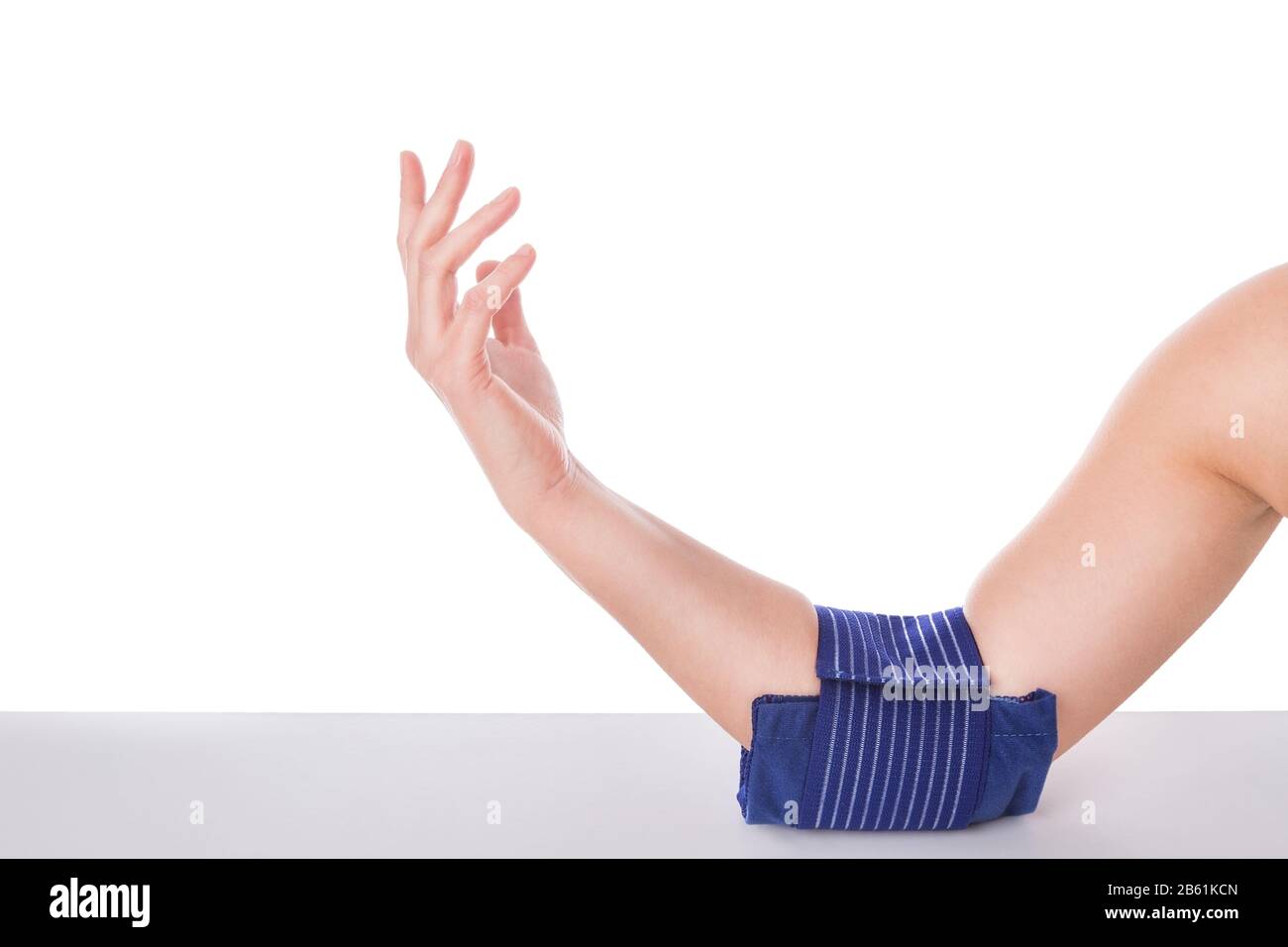 Girl with an elbow injury, icecooled gel. Sports injuries Stock Photo
