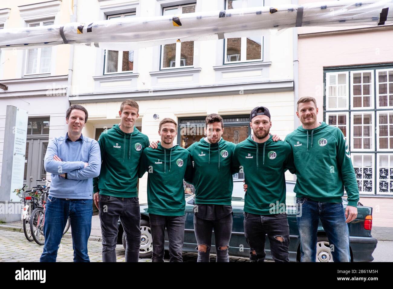 09 March 2020, Schleswig-Holstein, Lübeck: Jörg-Philip Thomsa, manager of the Günter Grass House (l-r) and the footballers of VfB Lübeck, Tommy Grupe, Lukas Raeder, Morten Rüdiger, Ahmet Arslan, Patrick Hobsch and Lukas Raeder pose in front of the Günter Grass House with an original goal from the football World Cup semi-final match Germany vs. Brazil from 2014 (1:7). The goal will be on display along with other exhibits from March 16 in the exhibition 'Günter Grass: My Football Century'. Photo: Frank Molter/dpa Stock Photo