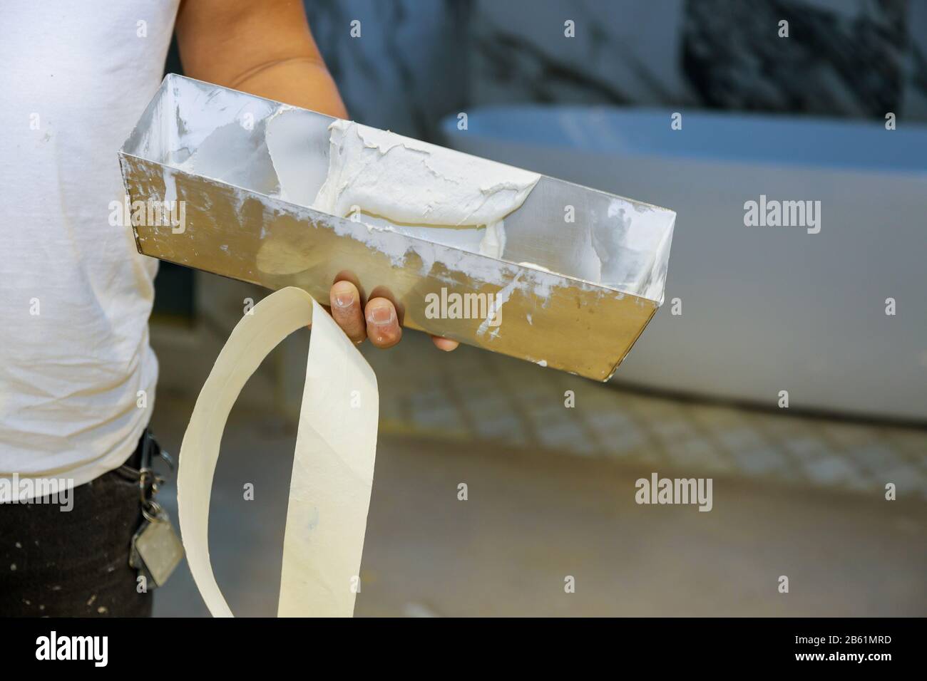 Work hand tool wall using plastering tool for unfinishing wall Stock Photo