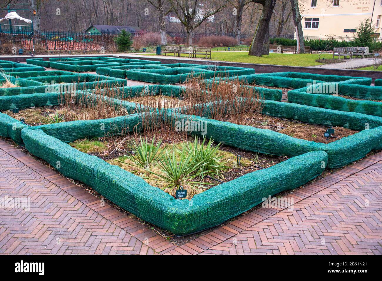 Plants and trees in a park covered with plastic sheets to protect them
