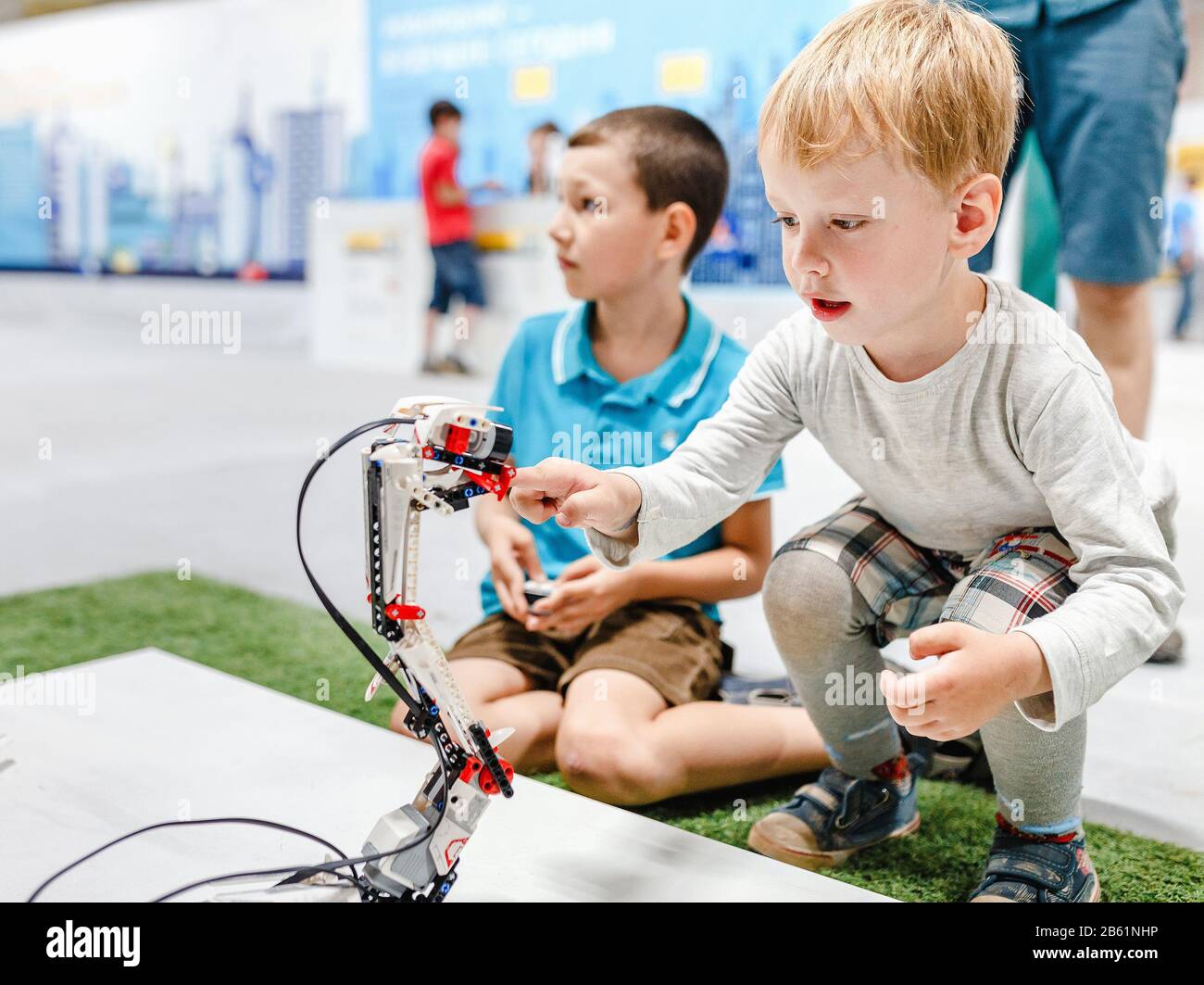 ULTRA MALL, UFA, RUSSIA, 21 AUGUST, 2017: Kid boy playing with interactive robot toy at the exhibition Stock Photo