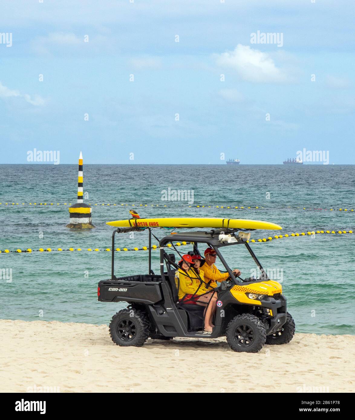 Surf lifesavers riding a buggy along Cottesloe Beach Perth WA Australia Stock Photo