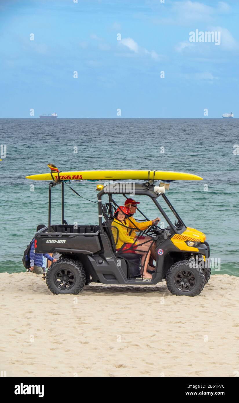 Surf lifesavers riding a buggy along Cottesloe Beach Perth WA Australia Stock Photo