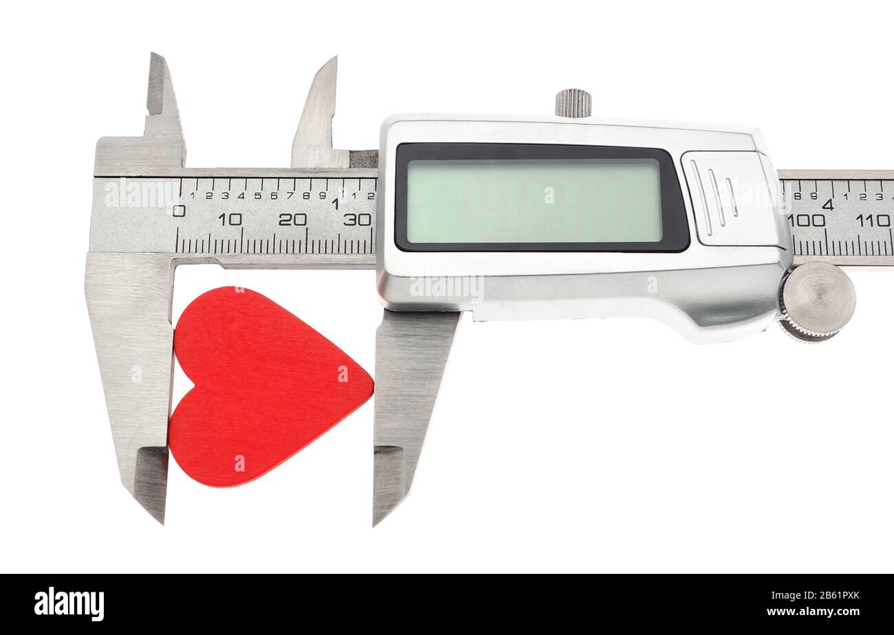 Vernier caliper measures the heart. On Valentine's Day. Stock Photo