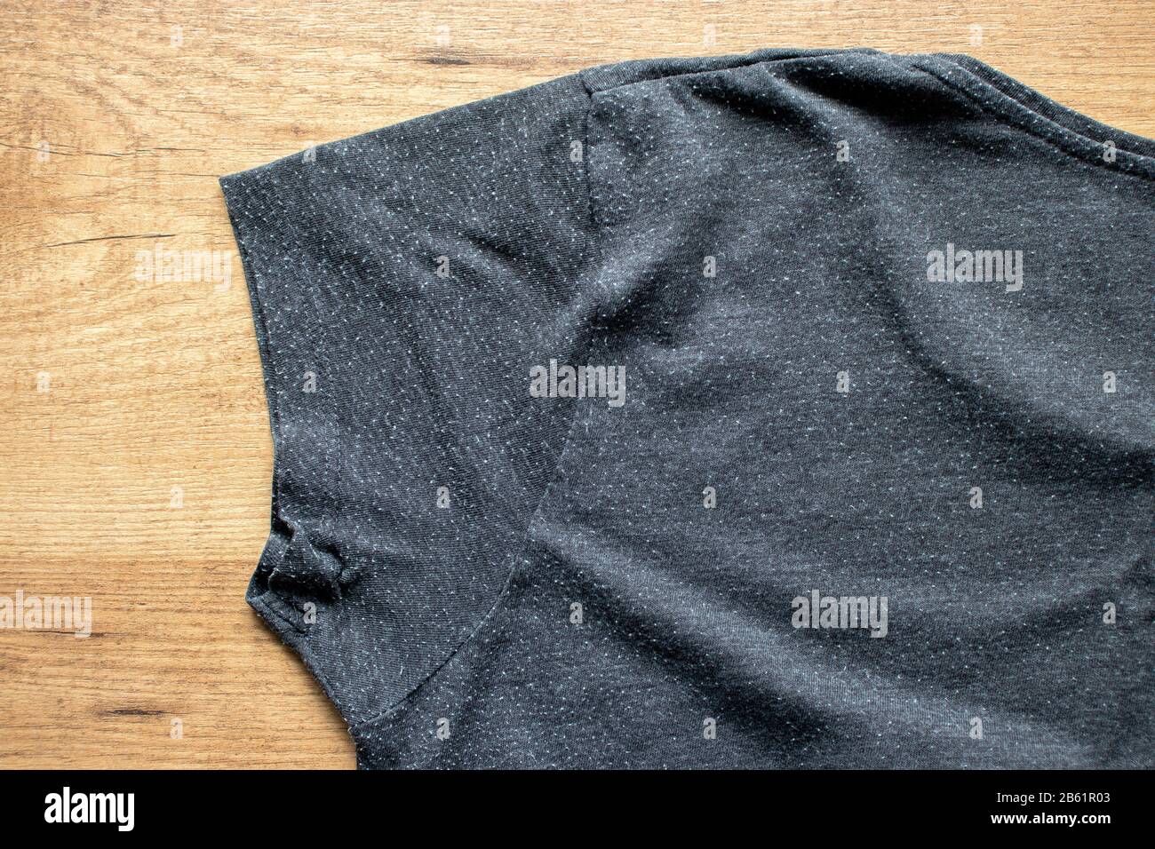 Pills on the gray tee-shirt cotton knit fabric. Bobbles on the knitwear. Stock Photo