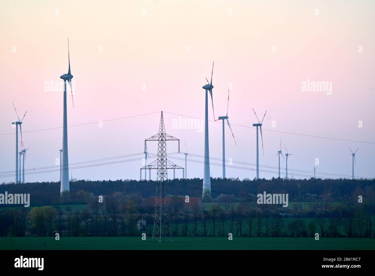 Wind turbines on countryside wind park at sunset Stock Photo