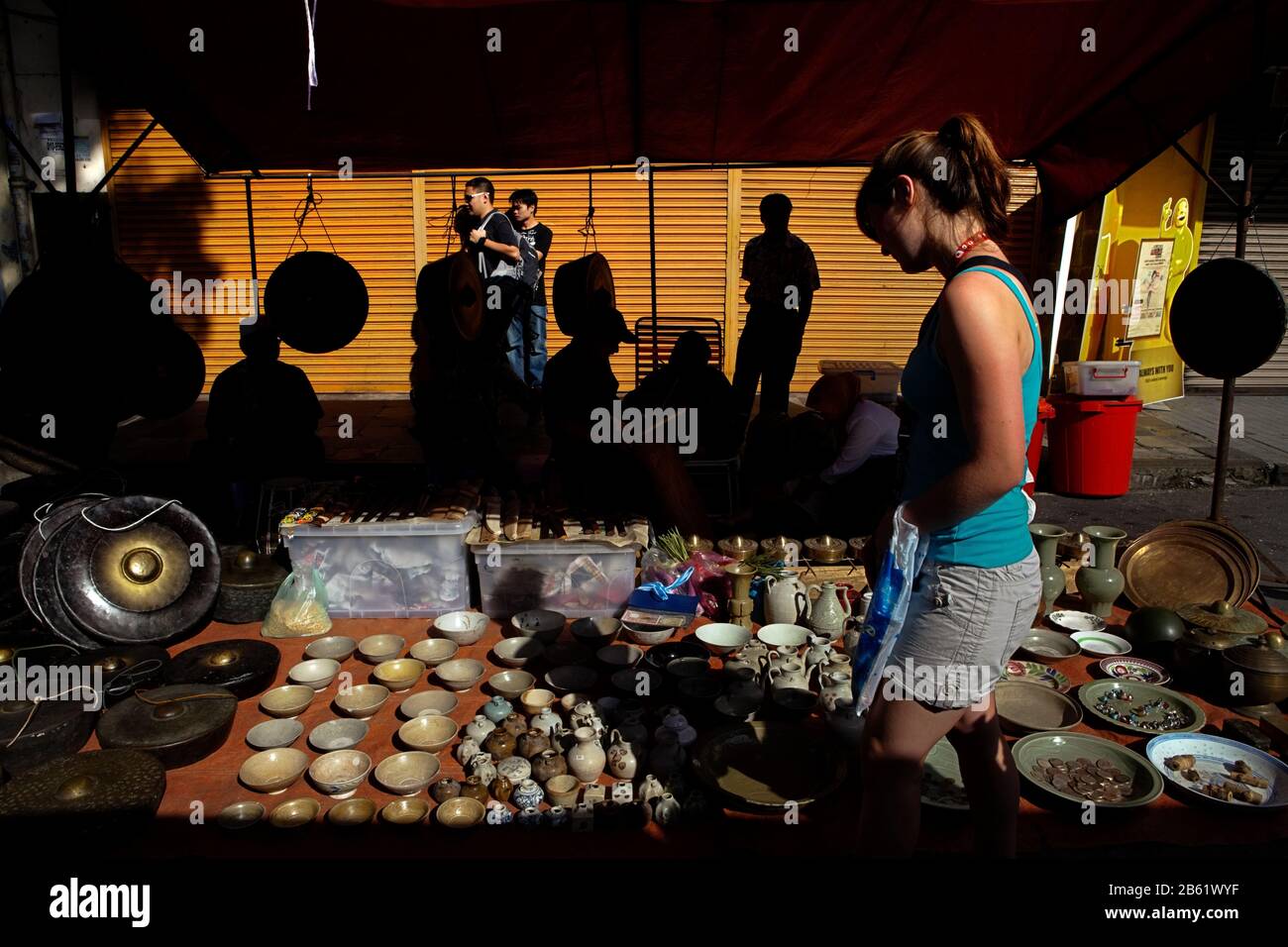 Tourist visiting porcelain craft shop at Gaya Street Sunday Market in Kota Kinabalu, Sabah, Malaysia. Stock Photo