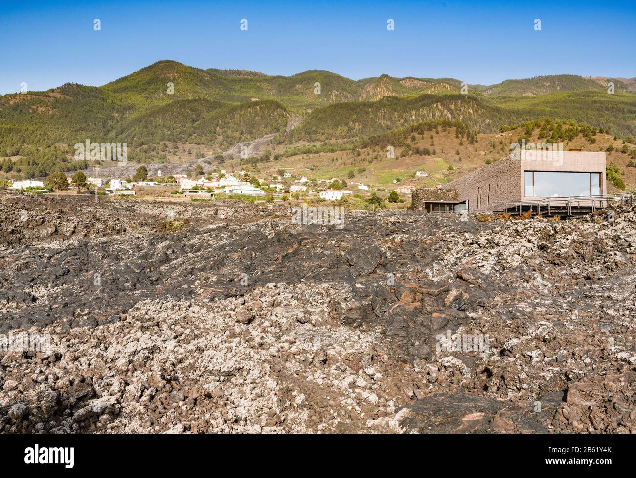 Pahoehoe lava from the 1949 eruption of San Juan volcano near Cueva de las Palomas, La Palma, in 2018 with newly built visitor cente then unopened Stock Photo