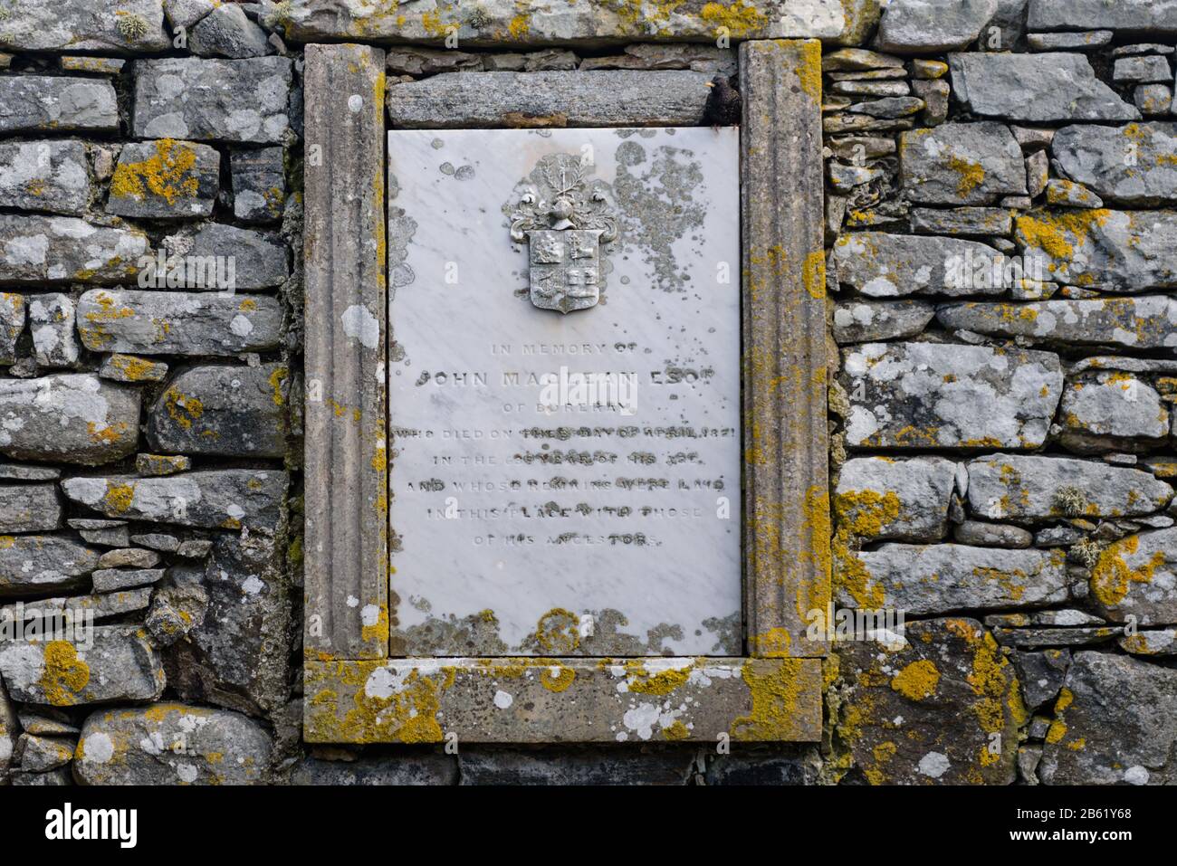 Memorial Stone inside the walls of The Maclean Cemetery on North Uist in the Outer Hebrides Stock Photo