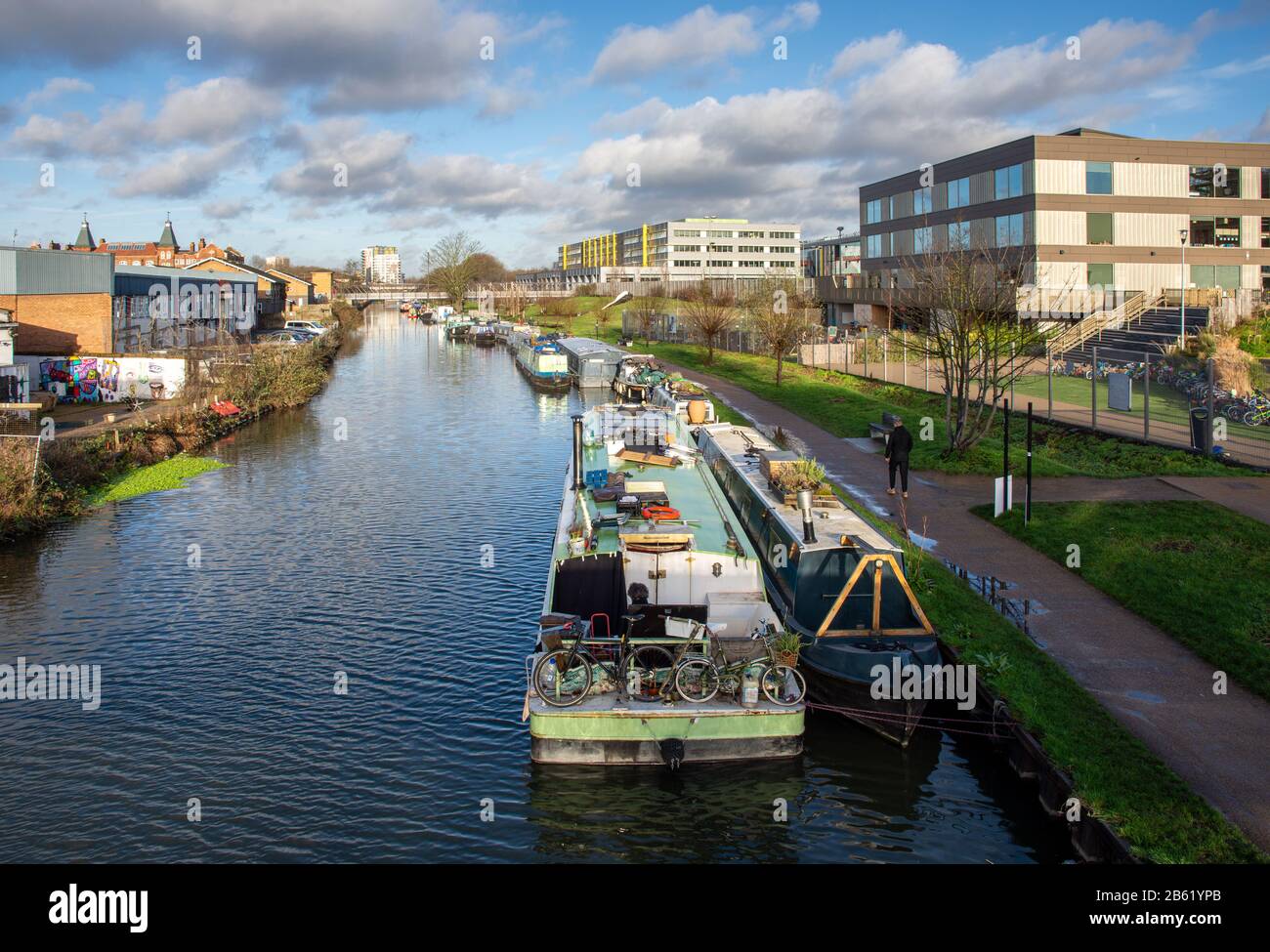 London, England, UK - January 17, 2020: Houseboats are moored in the River Lea Navigation beside the regenerated Hackney Wick neighbourhood of East Lo Stock Photo