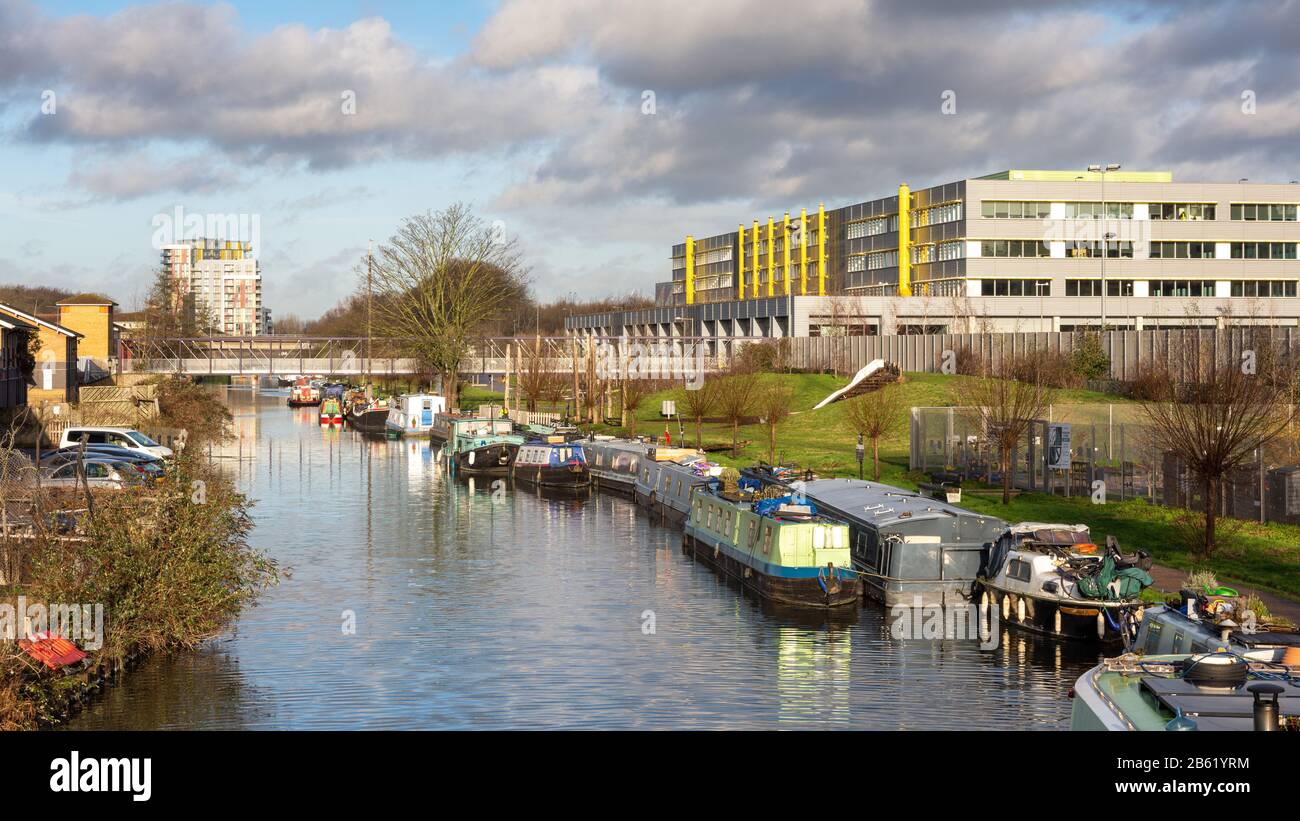 London, England, UK - January 17, 2020: Houseboats are moored in the River Lea Navigation beside the regenerated Hackney Wick neighbourhood of East Lo Stock Photo