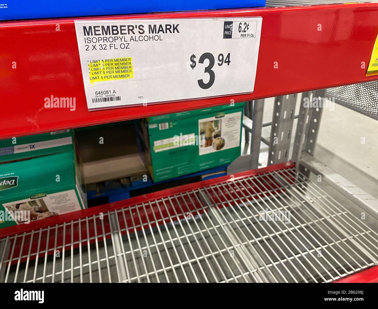 Orlando,FL/USA-3/7/20: A sign that says limit 5 per member on an empty shelf of Isopropyl alcohol at a Sams Club due to fear of the coronavirus custom Stock Photo