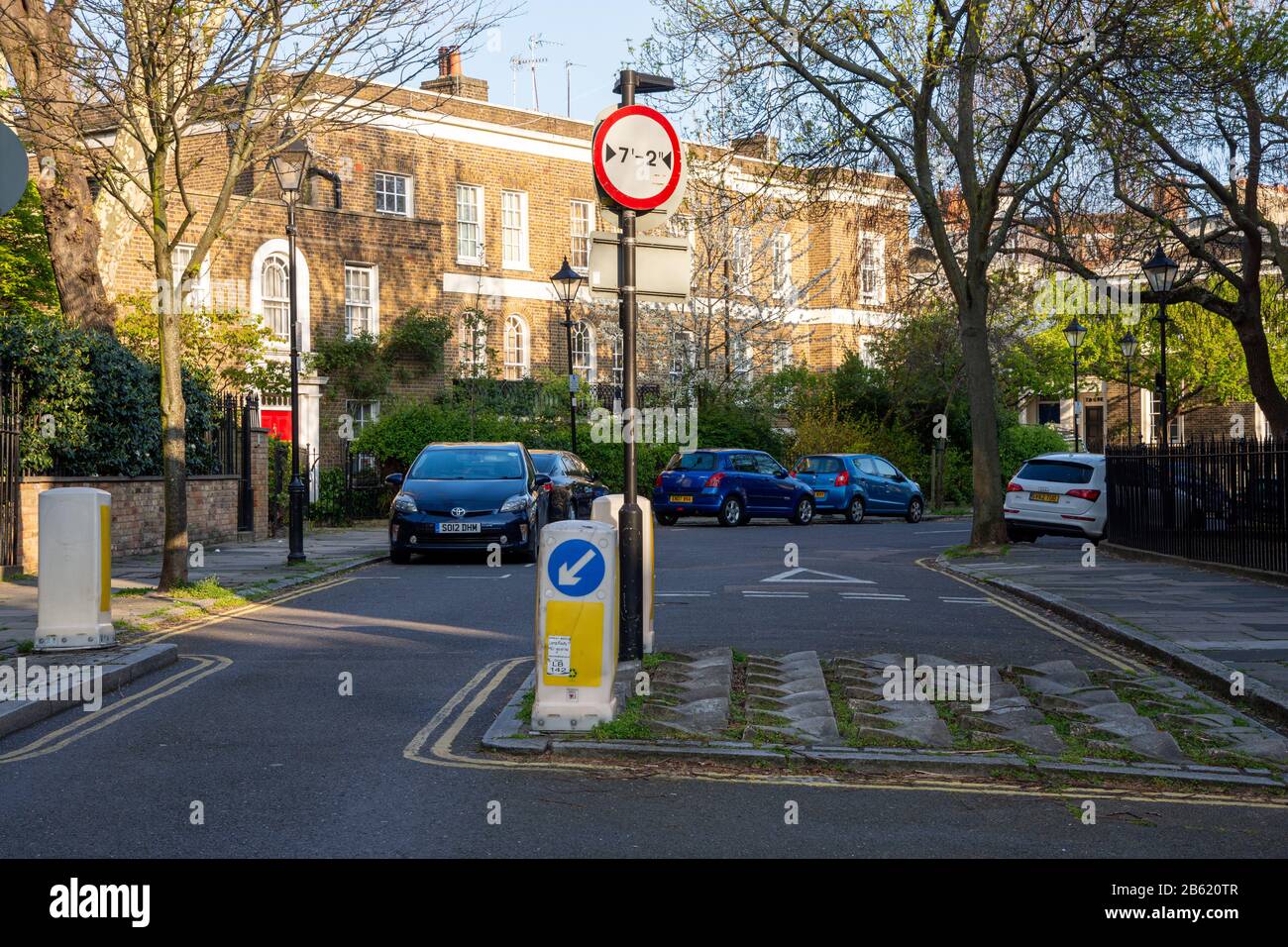 London, England, UK - April 11, 2019: An example of a traffic calming and filtering feature, restricting wide vehicles from a residential area, while Stock Photo