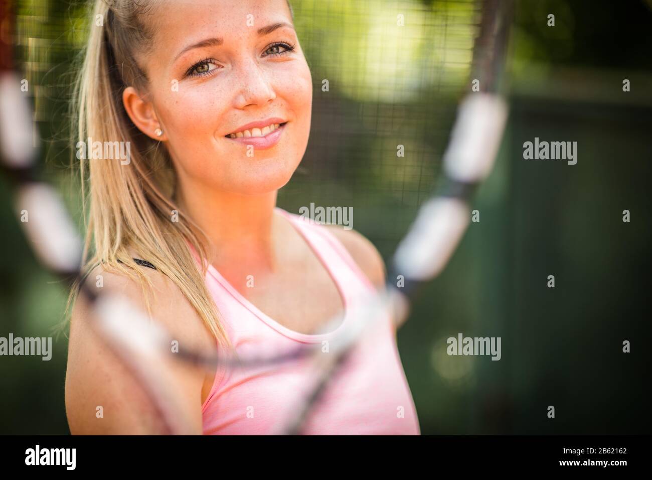 Pretty, young woman tennis player playing on a clay court. Healthy