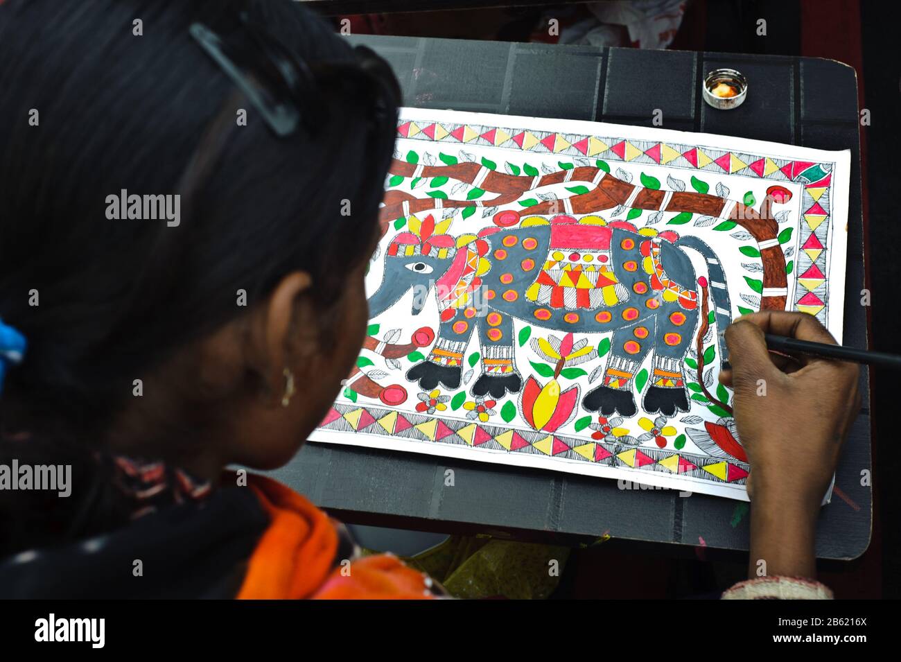 Teenage girl taking drawing lessons in a drawing school ( India). She is learning the Madhubani style of painting. Stock Photo