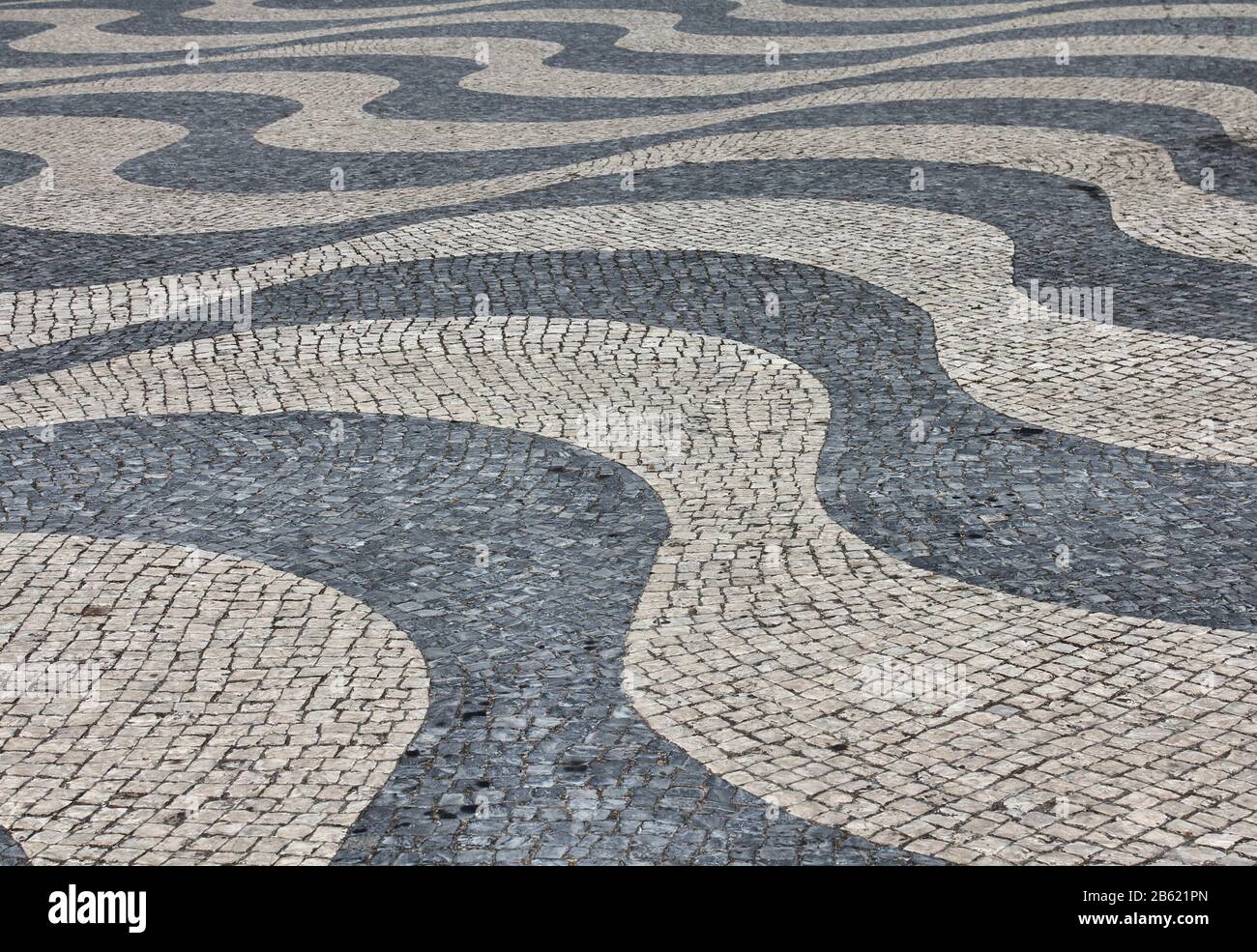 Black and white stone pavement mosaic in Lisbon, Portugal Stock Photo