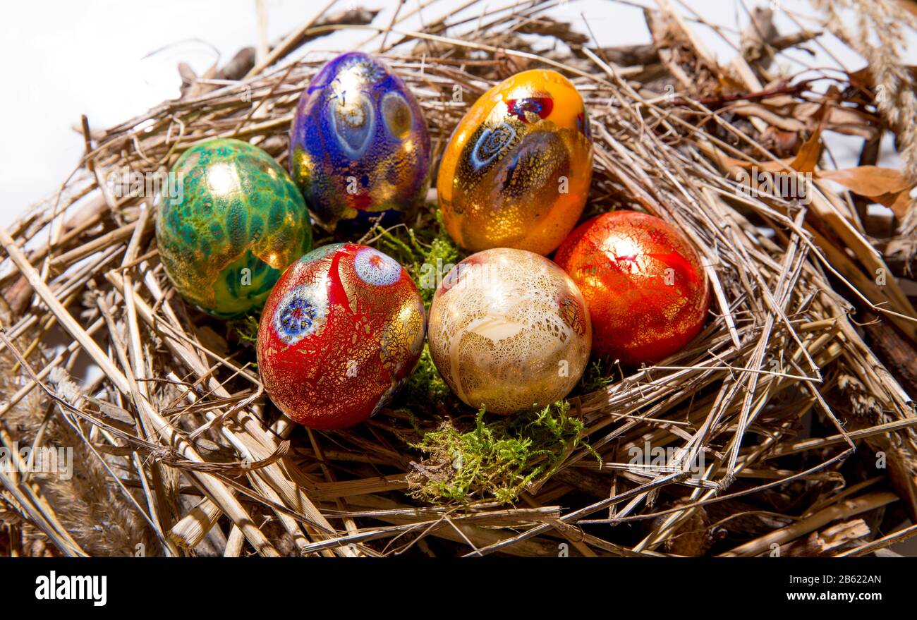 Six colorful painted Easter eggs in a nest Stock Photo - Alamy