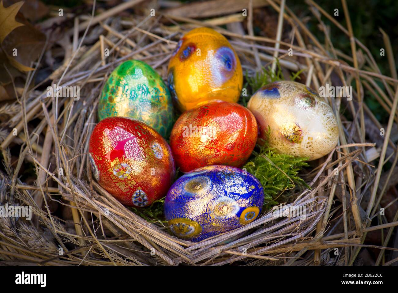 Six colorful painted Easter eggs in a nest Stock Photo - Alamy