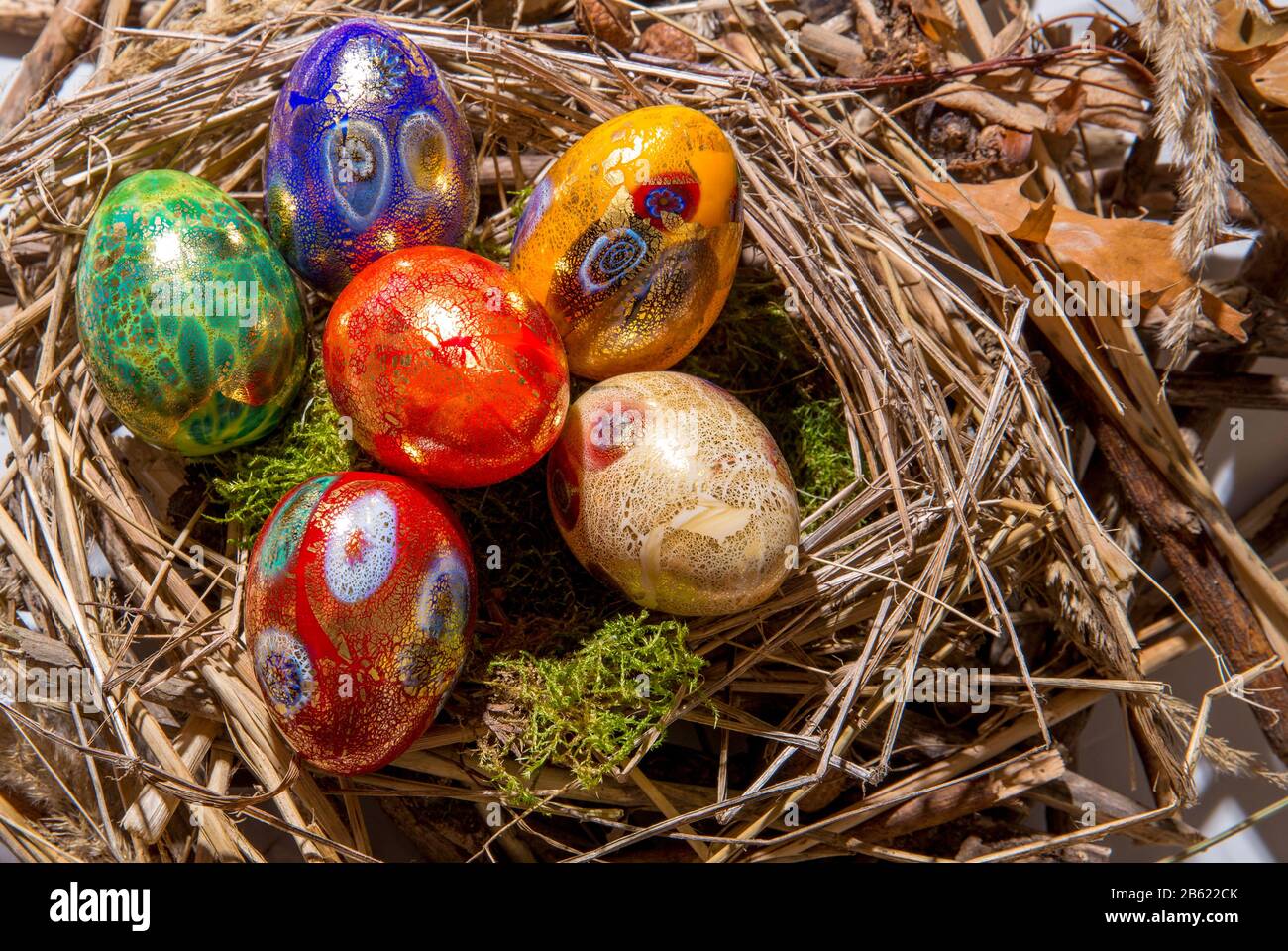 Six colorful painted Easter eggs in a nest Stock Photo
