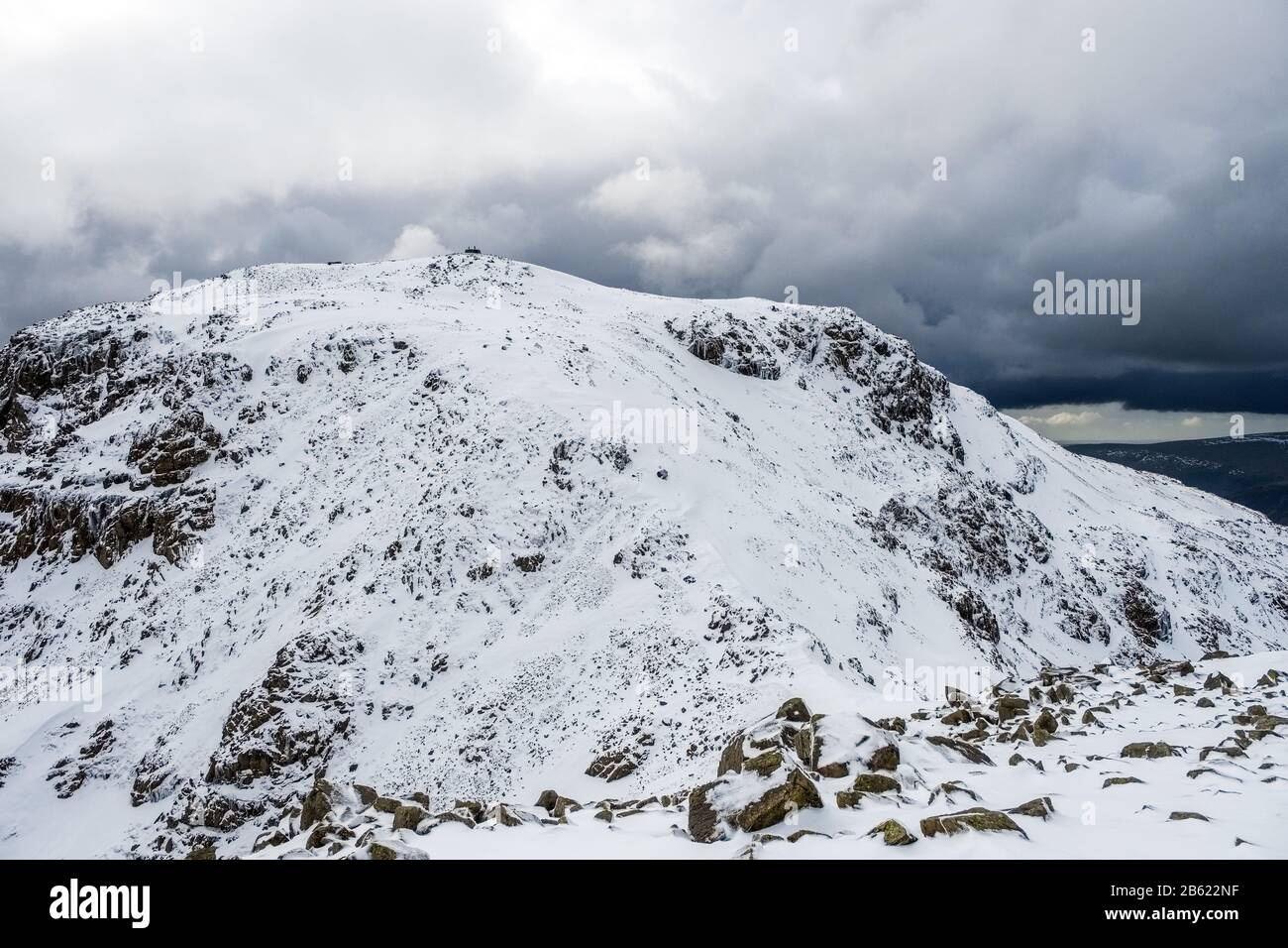 The snow covered summit of Scafell Pike, England's highest mountain, in