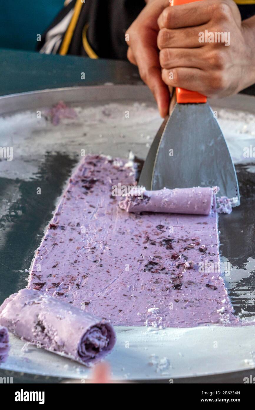 Making rolled ice cream, a Thai street food 