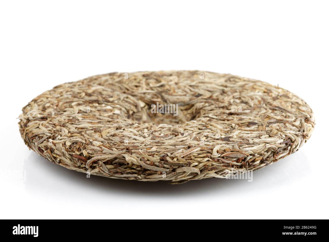 Disc of Chinese pu erh tea shot on white background Stock Photo