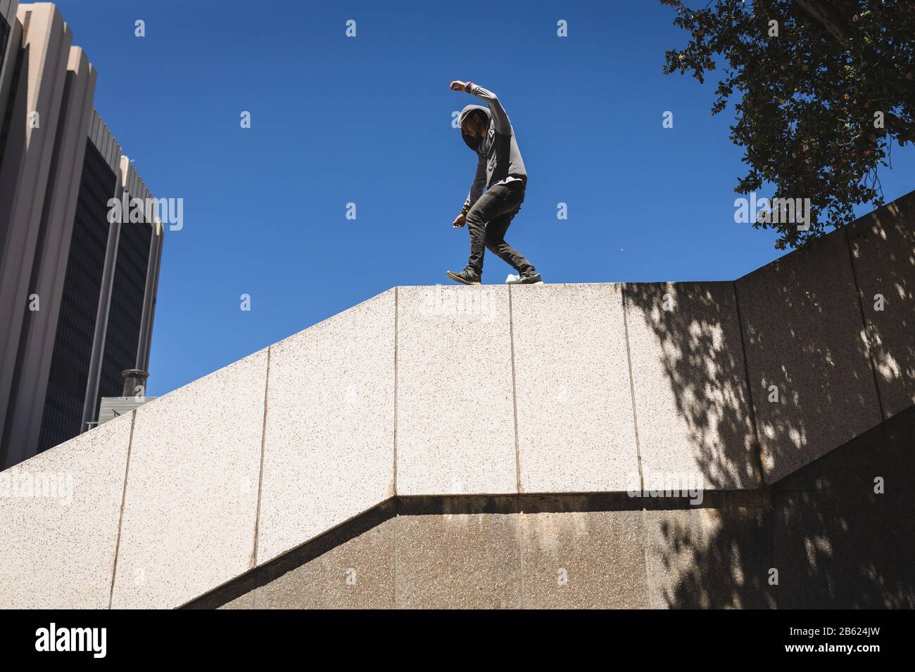 Caucasian man walking on walls Stock Photo