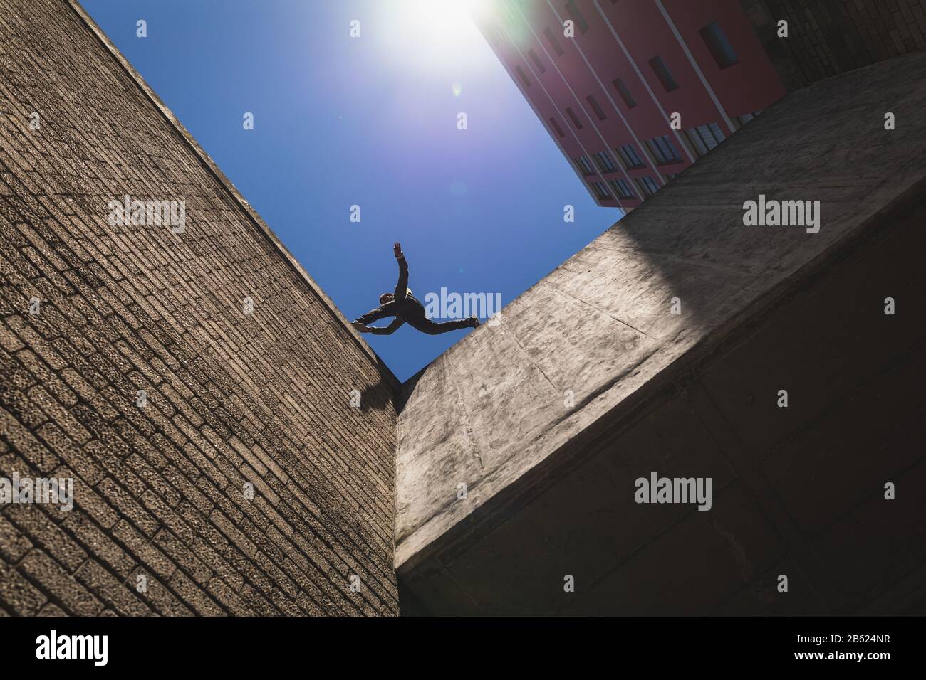 Caucasian man jumping from building Stock Photo